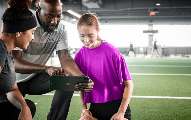 Gym owner using management software to monitor operations and member activity